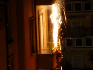 Kids, don't try this at home. Our neighbor across the street shot off Roman Candles from his oh-so-tiny balcony on NYE. Note the Santa figure climbing a ladder hanging from the balcony. And this goes on all over the city!
