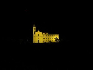 An unidentified church seem s to float in the darkness, just beyond Villa d'Este.